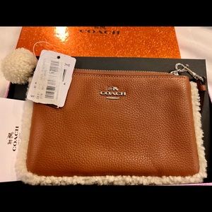Coach wristlet new with tags. Tan color